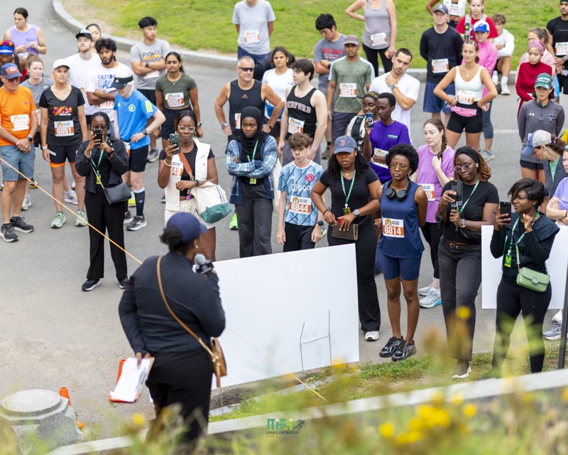 Runners and walkers gather to hear the race briefing